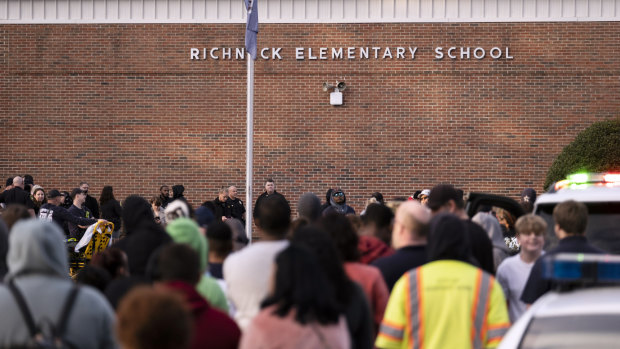 Students and police gather outside of Richneck Elementary School after the shooting.