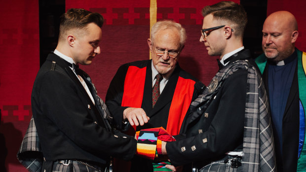 Reverend John Hirt blesses Curtis Dickson and David Barrow with a stole at their September wedding.