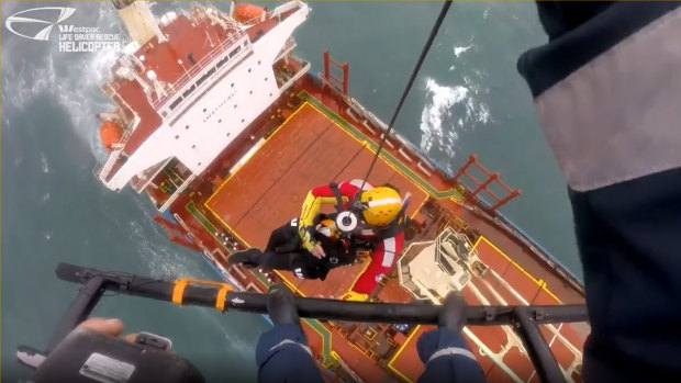 A rescue helicopter attempts to reach crew on the Portland Bay cargo ship stranded off the Royal National Park.