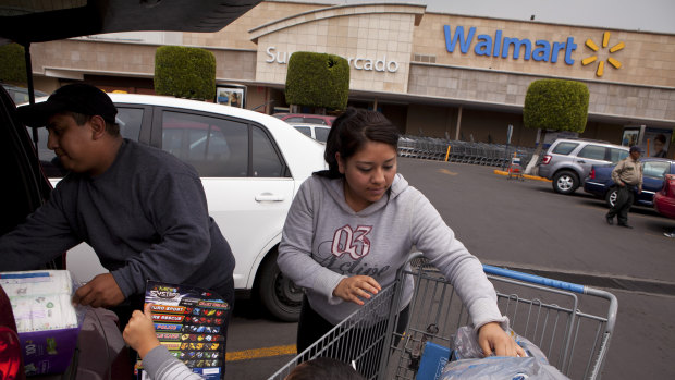 Shoppers unload groceries at a Walmart store in Mexico City.
