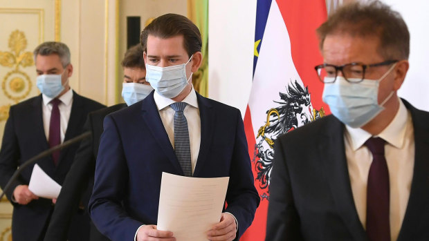 Austrian Chancellor Sebastian Kurz, centre, arrives for a coronavirus news conference with other ministers in Vienna.