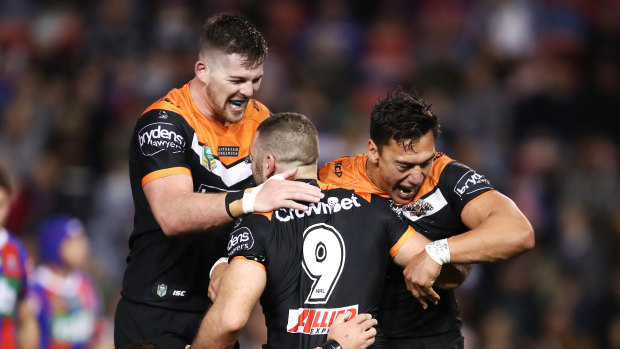 Staying alive: Robbie Farah scores an important try to give the Tigers a match-winning lead against the Knights.