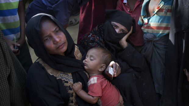 Rohingya refugee women queue up outside a relief distribution center at Kutupalong near Cox's Bazar, Bangladesh.