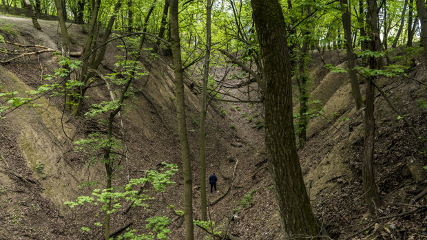 A woman walks in a ravine on the outskirts of Kiev, Ukraine, the area where, in September 1941, the Nazis shot tens of thousands of Jews, Roma, Ukrainian and Russian prisoners of war.