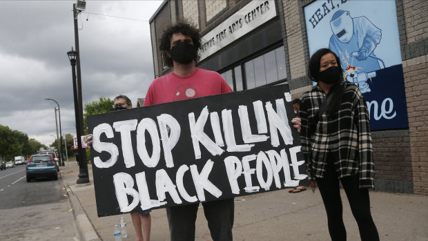 Protesters gather near the site of the death of a man, who died in police custody on Monday night in Minneapolis.