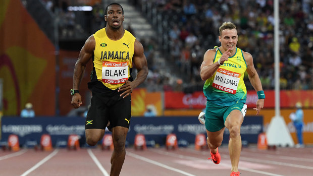 In his stride: Yohan Blake finishes ahead of Trae Williams during the mens 100m semi-final.