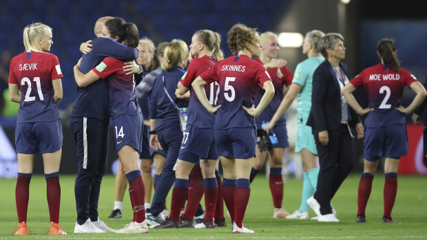 Norway players and officials console each other after the 3-0 loss to England.