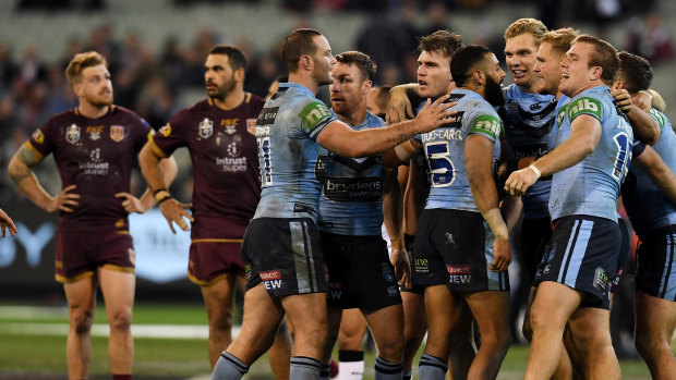 Blues players celebrate after winning Game 1 of the 2018 State of Origin series at the MCG.