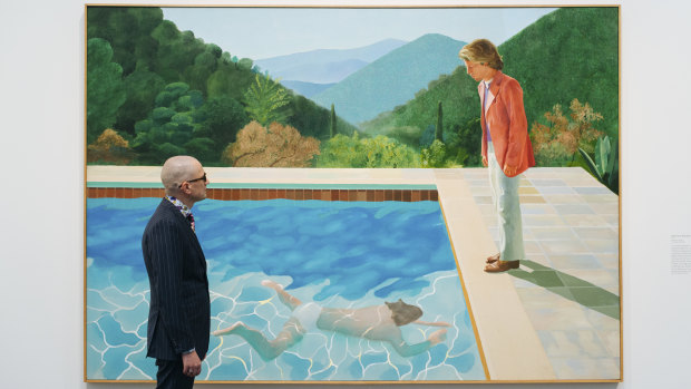 A viewer looks at David Hockney’s Portrait of an Artist (Pool with Two Figures) at a retrospective exhibition last year.