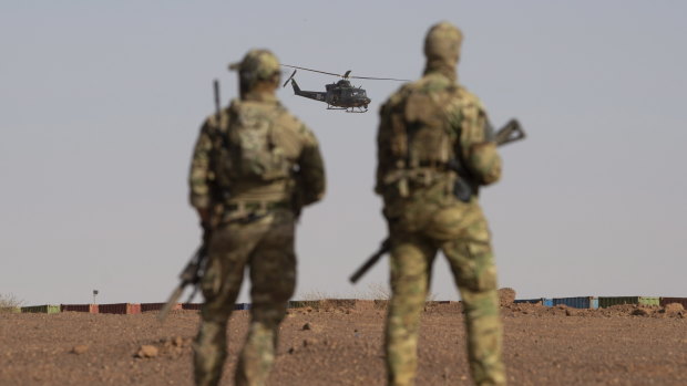 Canadian soldiers watch as a Canadian helicopter provides air security during a demonstration for Prime Minister Justin Trudeau on the United Nations base in Gao, Mali in December.