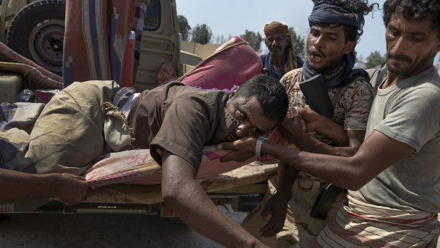 An injured Yemeni fighter with the Saudi Arabia-led Arab coalition, which is battling Iran-backed Houthis for control of Yemen, arrives at a field hospital.