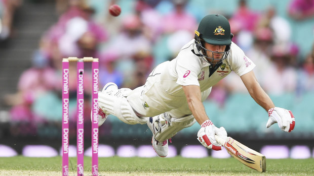 Joe Burns dives to make his ground on day three at the SCG. 