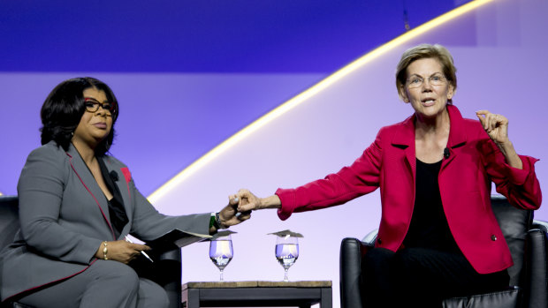 Senator Elizabeth Warren, right, speaks beside CNN political analyst April Ryan at the 110th NAACP Annual Convention in Detroit this week.