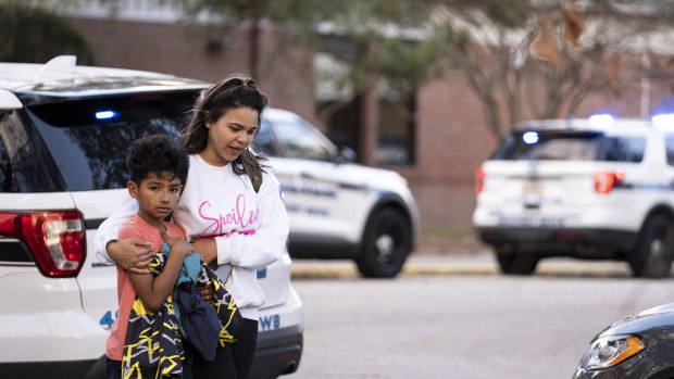 A fourth-grader leaves Richneck Elementary School with his mother after the shooting.