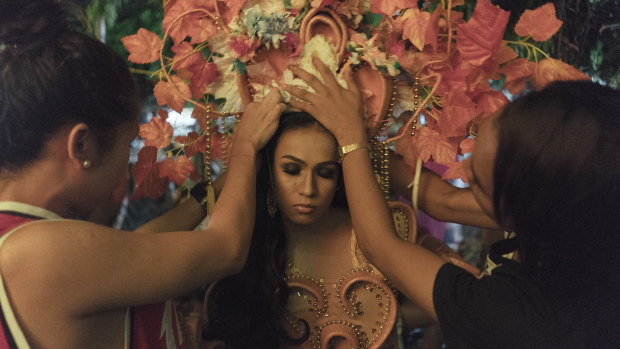Contestant Kim Prahinog dons an elaborate headdress at an annual transgender beauty pageant in Maria Respondo, Philippines.
