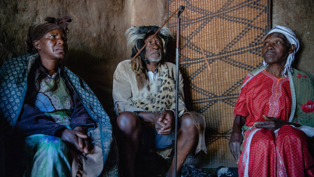Samuel Muriisa, 74, a herbalist who practices traditional medicine, with two of his wives, Jolly Twinomuhwezi, left, and Joyce Mazoba.