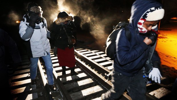 Eight migrants from Somalia cross into Canada illegally from the US by walking down a train track into the town of Emerson, Manitoba, in 2017. Migrant numbers have decreased since the outbreak of coronavirus.
