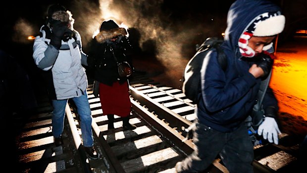 Eight migrants from Somalia cross into Canada illegally from the US by walking down a train track into the town of Emerson, Manitoba, in 2017. Migrant numbers have decreased since the outbreak of coronavirus.