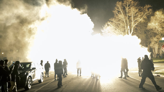 Authorities use flash bombs to disperse the crowd.