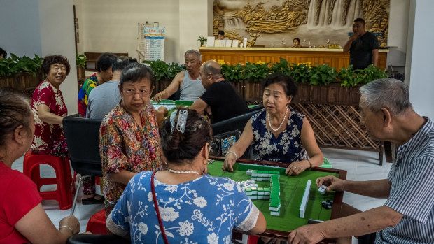 Playing mahjong at the Nuanchao Snowbirds Retirement Apartment in Sanya, China. 
