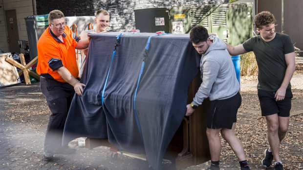 Residents packing up items including a piano from their units in the Mascot Towers Building.