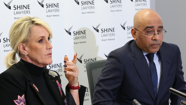 Ms Brockovich speaks with lawyer Roger Singh at a press conference at Shine Lawyers in Brisbane on Monday.
