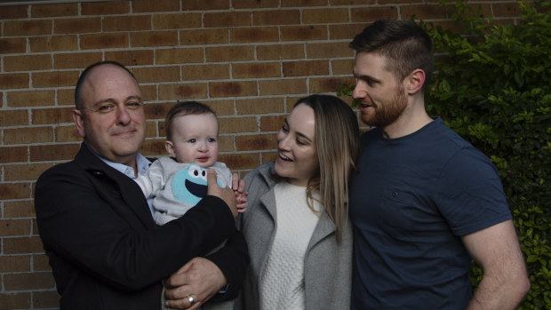 Clinical geneticist and lead researcher Associate Professor Tony Roscioli holds Riley Bell beside Riley's parents Rhiannon and Aidan, at their Barden Ridge home in Sydney.