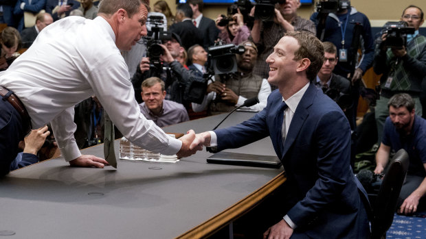 Congressman Markwayne Mullin greets Mark Zuckerberg as the Facebook founder faces a second day of questioning on Capitol Hill.