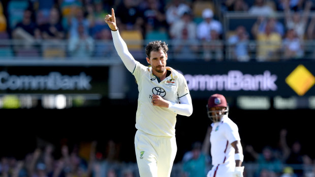 Mitchell Starc celebrates taking the wicket of Justin Greaves.