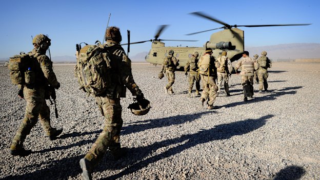 Australian troops from Special Operations Task Group and their Afghan counterparts from the Provincial Response Company walk to a CH-47 Chinook aircraft ahead of a mission.