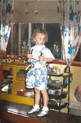 Amy aged three in overalls and frilly 
socks, a childhood favourite.