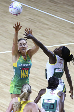 Over the top: Liz Watson tries to clear Zimbabwe's Claris Kwaramba.