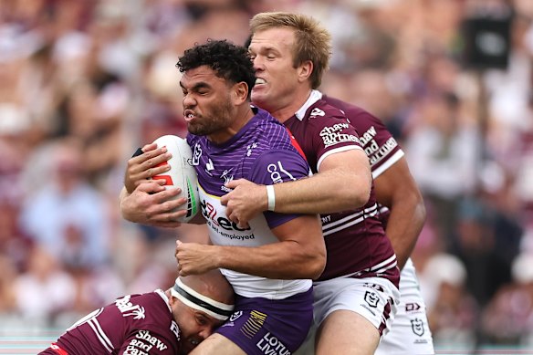 Melbourne’s Xavier Coates is tackled by Manly’s Jake Trbojevic.