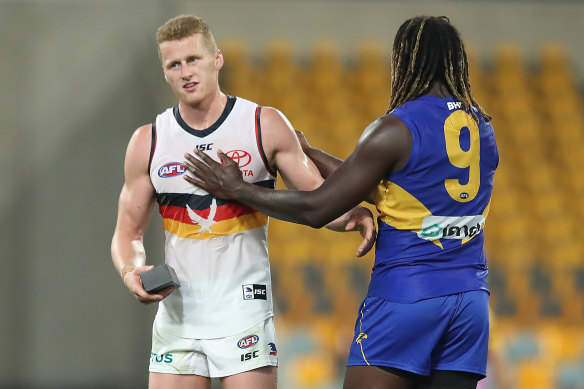 Reilly O'Brien holds a new phone courtesy of Nic Naitanui after their match earlier this year.