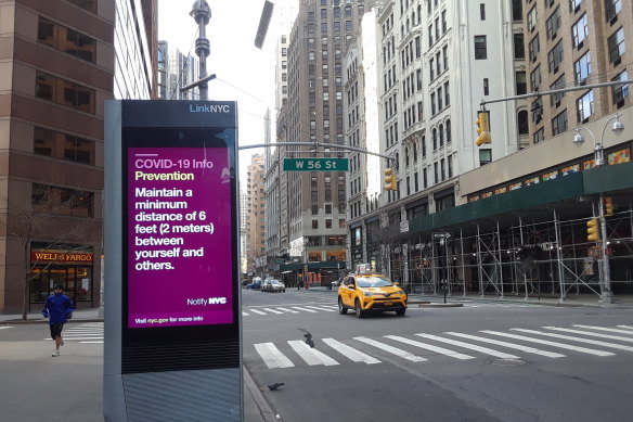 Electronic billboards repeat the COVID-19 message in New York.