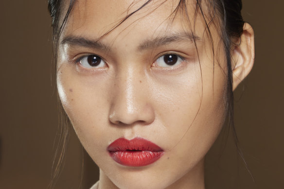 Make-up artist Diane Kendal used a punchy red lip with a backdrop of fresh dewy skin and a nude eye for this look.