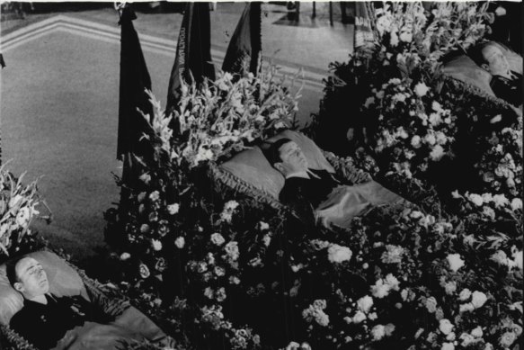 Russia's three Soyuz-11 cosmonauts lie-in-state, surrounded by masses of flowers, in Moscow's Central House of the Soviet Army. They are, left to right: Viktor Patsayev, 33, Vladislav Volkov, 37, and Lt. -Col. Georgi Dobrovolsky, 43, July 1, 1971.