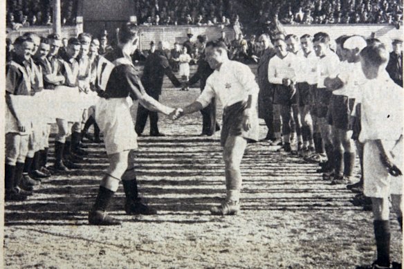 Australia and Palestine players shake hands before a soccer match in Sydney, on July 31, 1939. 