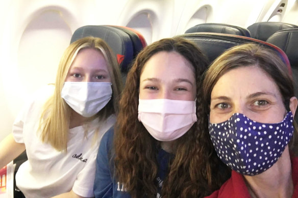 Sandy Duffield with her daughters Luca, 16, and Zara, 13 on the flight home. 