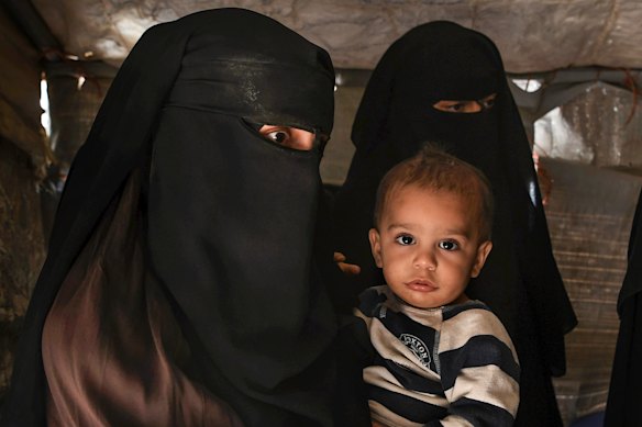 Zahra Ahmed (left) and her baby, Ibrahim, photographed in al-Hawl camp in 2019.