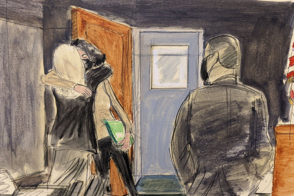 In this courtroom sketch, Ghislaine Maxwell, centre, hugs her defence lawyer, Laura Menninger, immediately after walking out of lock-up after a four-day break.