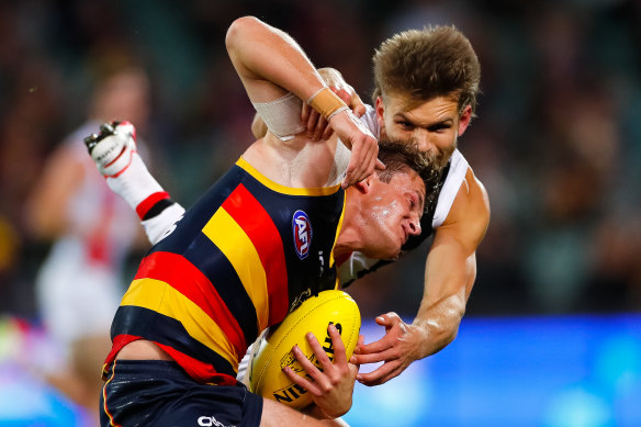 St Kilda's Dan Butler collars Adelaide's Matt Crouch.