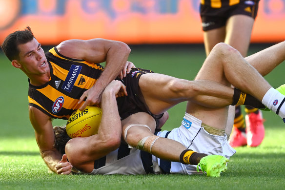 Hawks star Jaeger O’Meara is tackled during the Easter Monday clash with Geelong at the MCG.