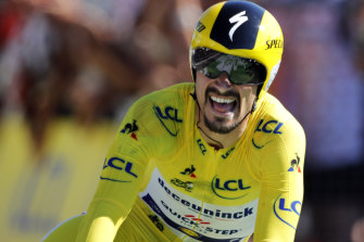 Julian Alaphilippe crosses the line to extend his lead over Geraint Thomas.