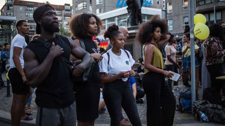 A crowd gathers at a street festival organised to raise awareness of the cultural heritage of the street name Mohrenstrasse, in Berlin. 