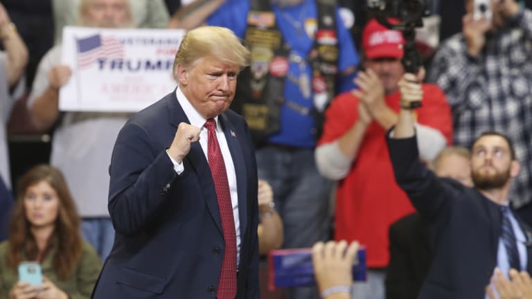 President Donald Trump pumps his fist as he leaves after speaking at a campaign rally in Minnesota in October. 