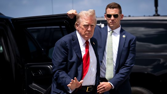 Former President Donald Trump boards his plane at the West Palm Beach Airport for a flight to a campaign rally in Charlotte, North Carolina.