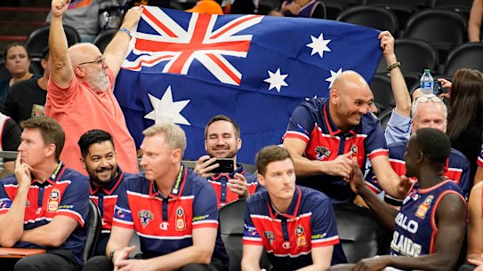 Australian fans celebrate behind the 36ers’ bench.