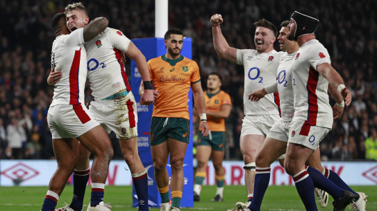 England’s Freddie Steward, second left, celebrates after scoring the opening try during the rugby union international between England and Australia at Twickenham stadium in London, Saturday, Nov. 13, 2021. (AP Photo/Ian Walton)