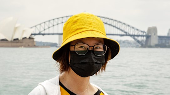 A tourist from Hong Kong wears a mask in Sydney as a precaution against coronavirus. on Wednesday. 
